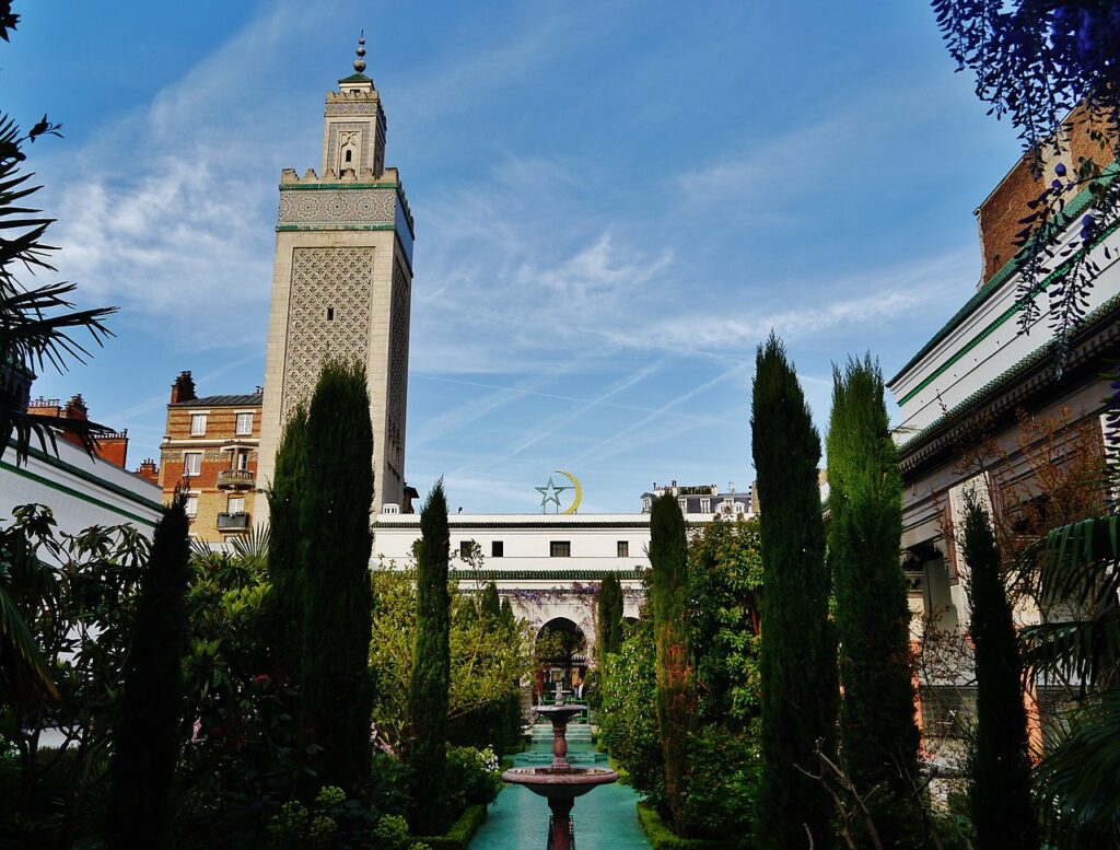 Gran Mezquita de París que muestra el interior que muestra un jardín interior con árboles y edificios detrás