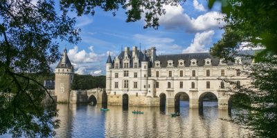 Chateau de Chenonceau construido en el lago con sus paredes blancas y torres visibles en el agua