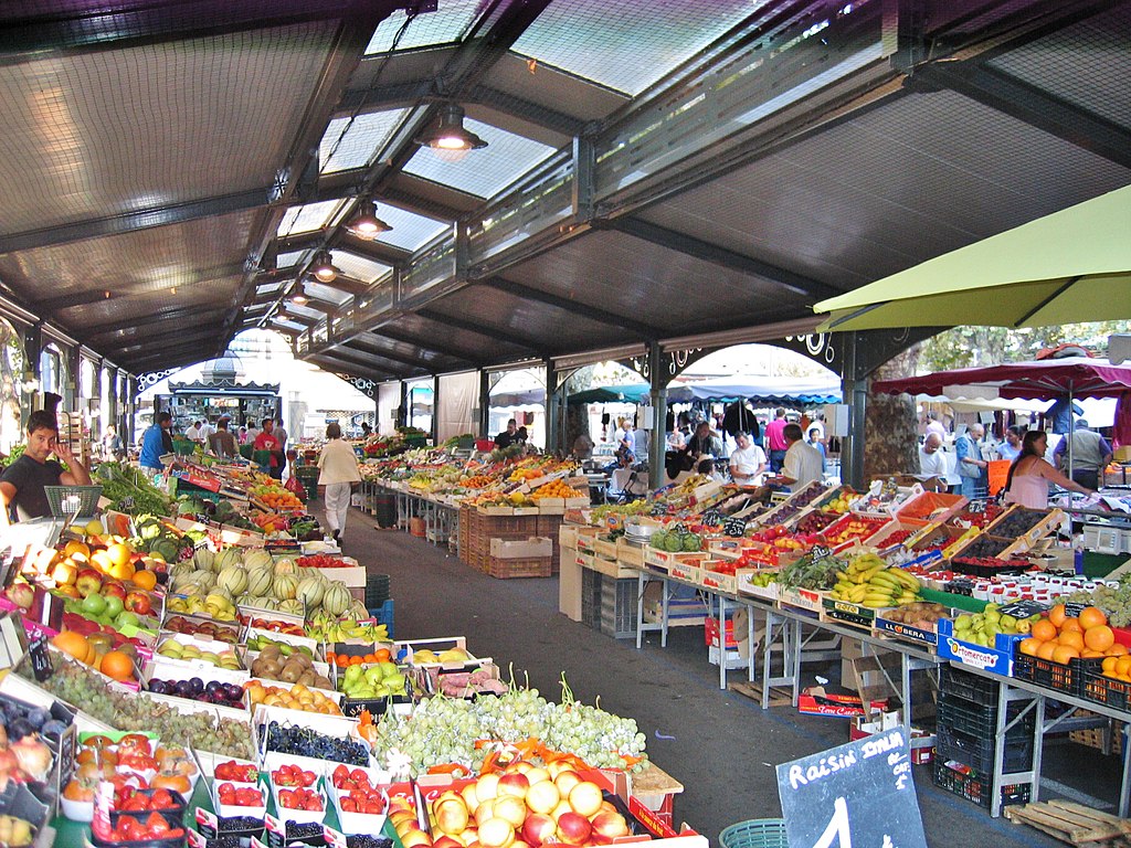 Cannes Gambetta Provence mercado mirando hacia un largo pasaje en la sección cubierta con fuit y puestos de verduras a ambos lados